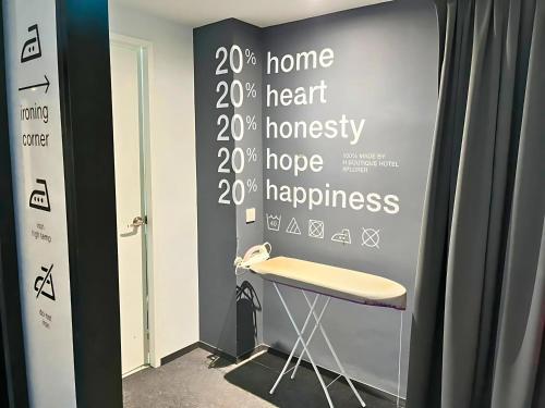 a chair in a room with a wall with words on it at Sky Hotel Cheras Maluri in Kuala Lumpur