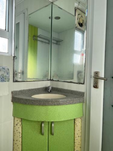 a bathroom with a sink and a mirror at Sea View Holiday House in Hong Kong