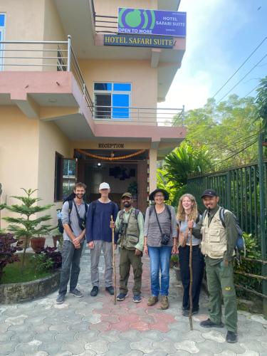 a group of people standing in front of a building at Hotel Safari Suite in Sauraha