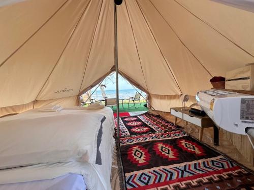 a room with a tent with a bed and a rug at The hi Ocean resort เดอะไฮโอเชี่ยนรีสอร์ต in Khlong Yai