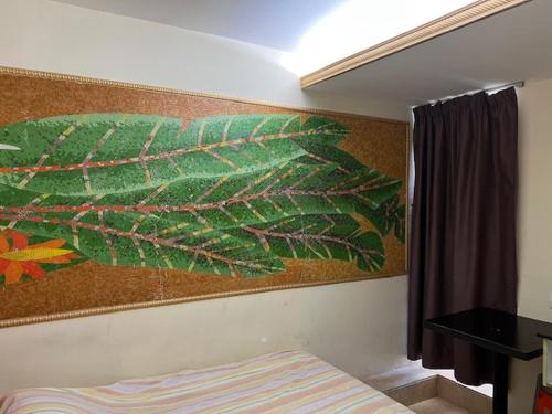a painting on the wall of a bedroom at Sea View Holiday House in Hong Kong