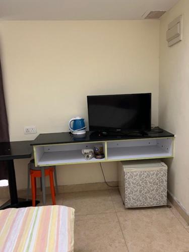 a flat screen tv sitting on top of a desk at Sea View Holiday House in Hong Kong