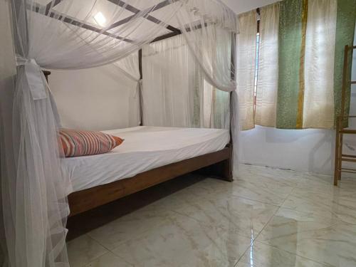 En eller flere senge i et værelse på Hetti Villa