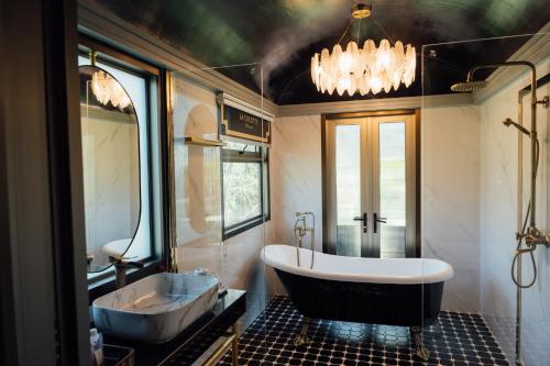 a bathroom with a large tub and a sink at LA COCOTTE VILLA & FARM KHAO YAI in Nong Sarai