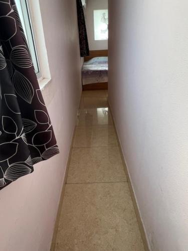 a hallway leading to a room with a window and a floor at Sea View Holiday House in Hong Kong
