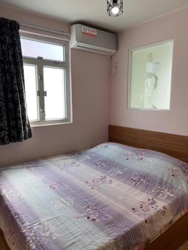 a bed in a bedroom with a window at Sea View Holiday House in Hong Kong