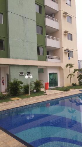 a building with a swimming pool in front of a building at Apartamento Manaus Arena da Amazonia in Manaus