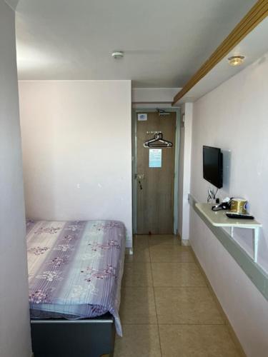 a room with a bed and a sink in it at Sea View Holiday House in Hong Kong
