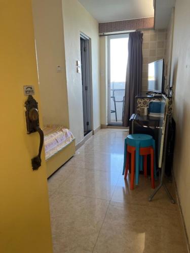 a room with a room with a table and a stool at Sea View Holiday House in Hong Kong