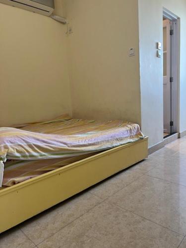 a bedroom with a yellow bed in a room at Sea View Holiday House in Hong Kong