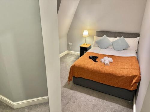 a bedroom with a bed with a teddy bear on it at Modern En-Suite Rooms by Finsbury Park Station 8 mins to King's Cross by Tube in London