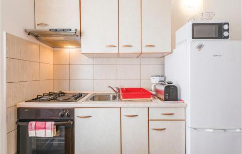 a small kitchen with a sink and a stove at One-Bedroom Holiday Home In Zminj in Žminj
