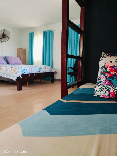 a bedroom with two beds and a mirror at Staycation in San Pablo laguna in San Pablo