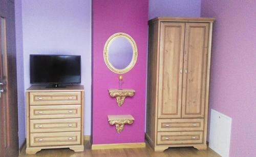 a living room with a mirror and a dresser at Willa Jula in Białystok
