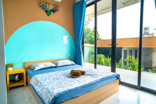a bedroom with a bed and a large window at TP-HOMES PHAN THIẾT in Phan Thiet