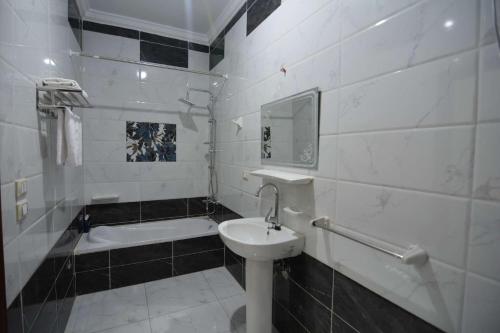 a white bathroom with a sink and a bath tub at 埃及江南人家 in Cairo