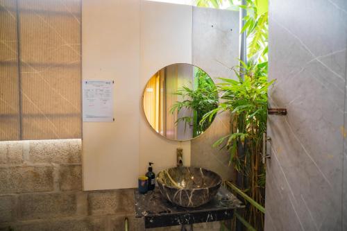 a bathroom with a sink and a mirror at TP-HOMES PHAN THIẾT in Phan Thiet