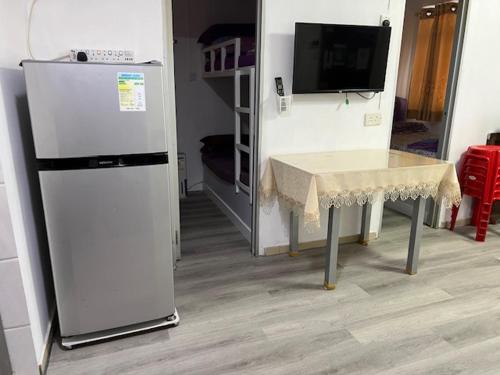 a kitchen with a table and a refrigerator at Sea View Holiday House in Hong Kong