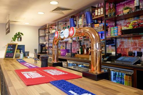 a bar with a faucet on the counter at Holiday Inn - the niu, Loom Manchester North by IHG in Manchester