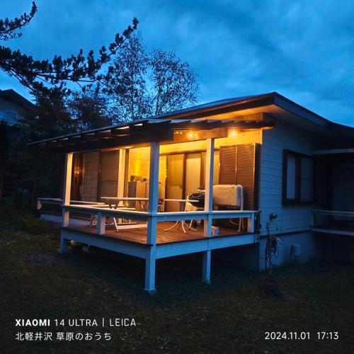a tiny house with a large deck at night at Kitakaruizawa Morino Bessou NO7 in Kita-karuizawa