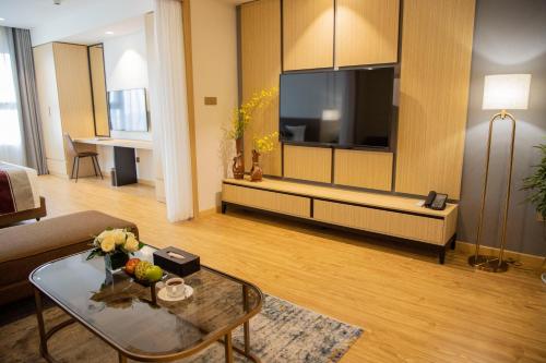 a living room with a large flat screen tv at Pearl River Hotel in Hai Phong