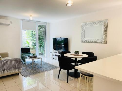 a living room with a table and chairs at D101 Charming Apartment- Free Parking in Melbourne
