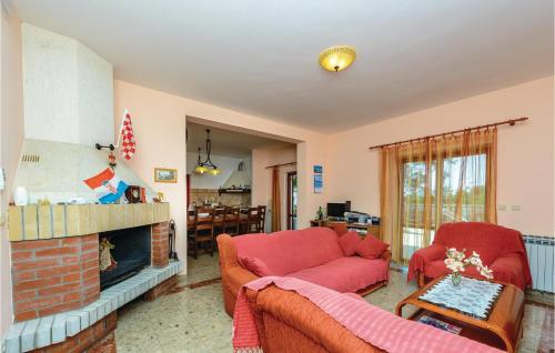 a living room with a red couch and a fireplace at Holiday Home Pinji Vi in Zaton