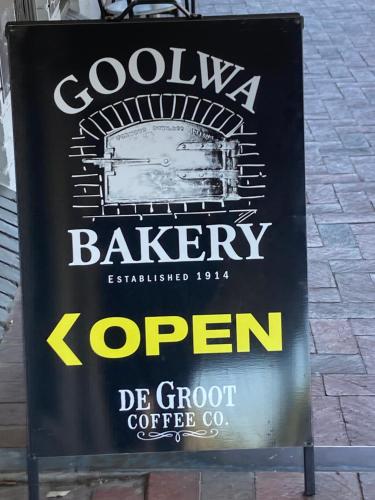a sign for a coffee shop on a street at Captains Cottage - Pet Friendly Breakfast Included in Goolwa