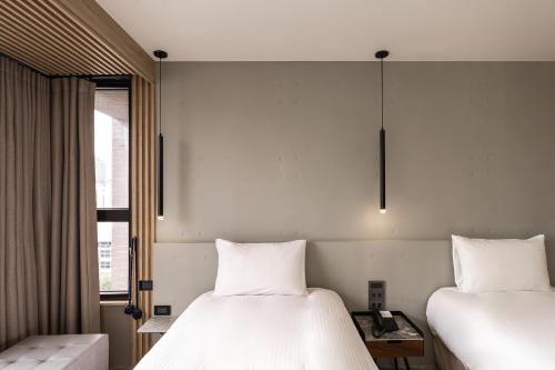 HOTEL LEISURE Kaohsiungにあるベッド