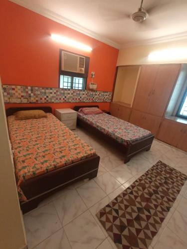 a bedroom with two beds and a mirror at WISHTREE CORPORATE MENS DORMITORY FOR TECHIES AND Trainees in Chennai