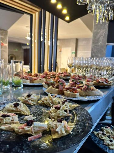 a buffet line of pizzas on plates on a table at Mantra Hotel Boutique in Santa Marta