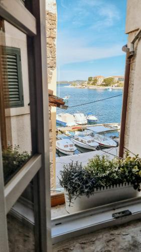 a view from a window with boats in the water at City Rooms Šibenik in Šibenik