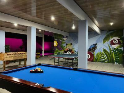 a billiard room with a pool table in the middle at Villas VJ in Puerto Limón