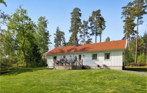 a white house with an orange roof at Nice Home In Norra Kedum With Wifi in Norra Kedum