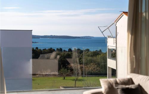 a view of the ocean from a living room window at Nice Home In Pula With Kitchen in Štinjan