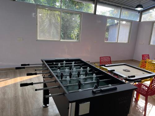 a room with a large pool table and two chairs at Hotel Suryaprabha- Near Diveagar Beach in Diveagar