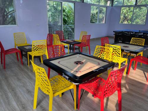 a room with tables and chairs with a ping pong table at Hotel Suryaprabha- Near Diveagar Beach in Diveagar