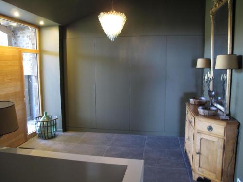 Una sala de estar con una mesa y una lámpara de araña. en Charmante maison d'hôtes avec salle de sport et repas maison - FR-1-582-507, en Saint-Bérain