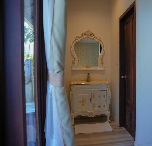 a bathroom with a dresser and a mirror at Villa Oasis in Luang Prabang