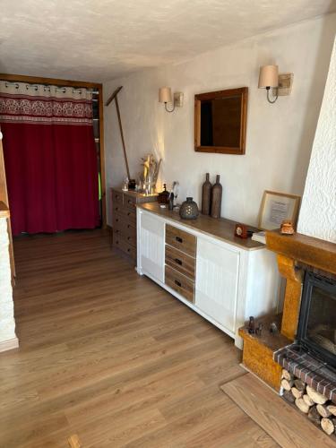 - un salon avec une cheminée et un rideau rouge dans l'établissement Studio avec cheminée et jardin, à Gréolières