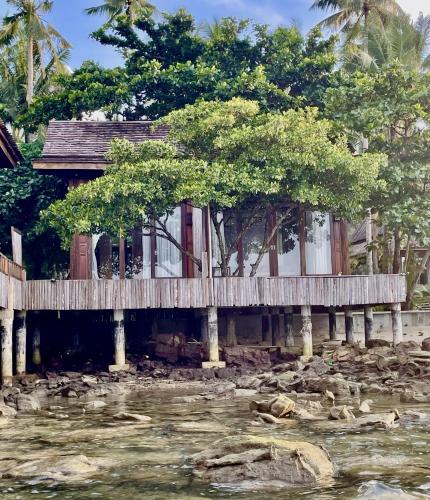 a house on a bridge over a river at Full Moon Island Resort in Kaoh Sdach
