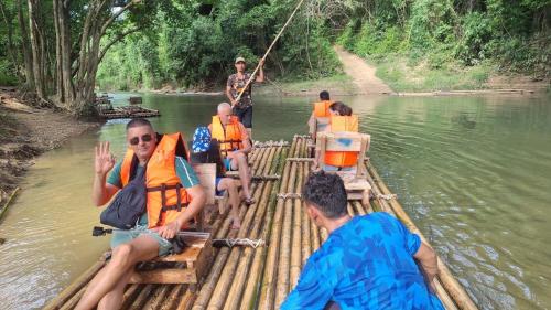 a group of people on a raft on a river at Amornkeeree Khao Sok Camping in Khao Sok