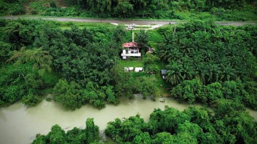 an aerial view of a house in the middle of a river at Amornkeeree Khao Sok Camping in Khao Sok