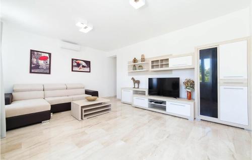 a living room with a couch and a tv at Nice Home In Kotor With Sauna in Kotor