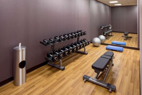 a gym with several rows of dumbbells and weights at Hyatt House New Orleans Downtown in New Orleans