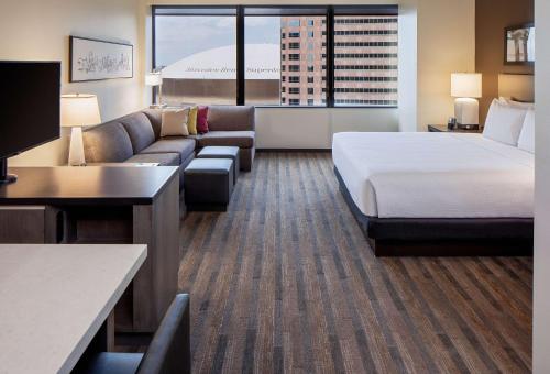 a hotel room with a bed and a couch at Hyatt House New Orleans Downtown in New Orleans