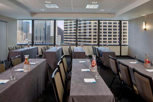 a dining room with tables and chairs and a large window at Hyatt House New Orleans Downtown in New Orleans