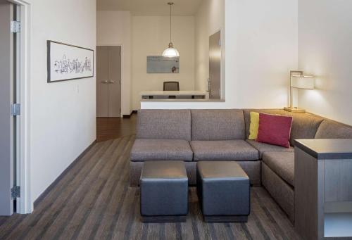 a living room with a couch and a table at Hyatt House New Orleans Downtown in New Orleans