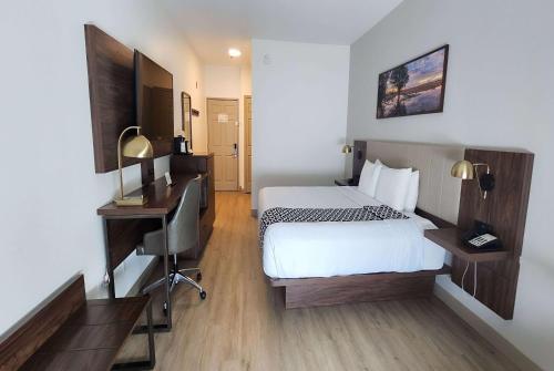 a hotel room with a bed and a desk at La Quinta by Wyndham Dallas Mesquite in Mesquite