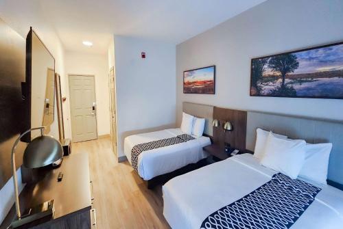 a hotel room with two beds and a desk at La Quinta by Wyndham Dallas Mesquite in Mesquite